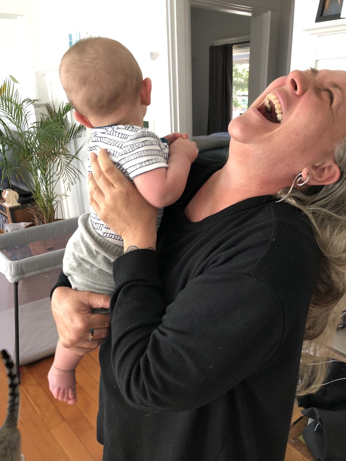 Willow Merchant holding a newborn during in-home postpartum doula support in Bend, Oregon